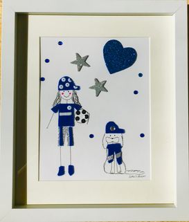 Girl footballer in blue and silver with dog framed wall art