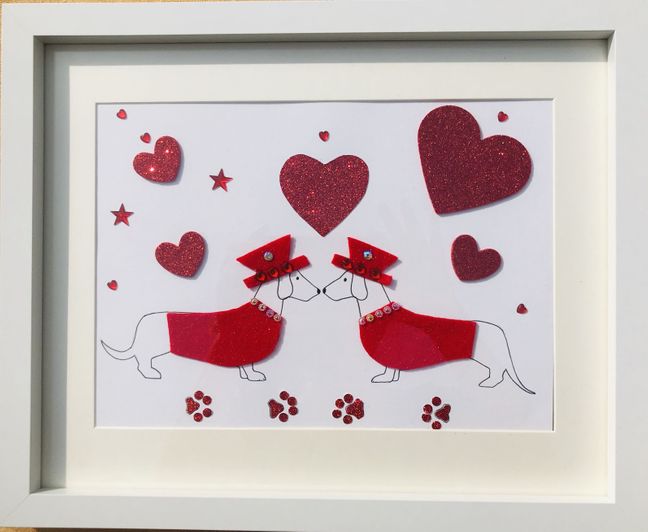 Beautiful pair of red sausage dogs with red coat and hat framed wall art
